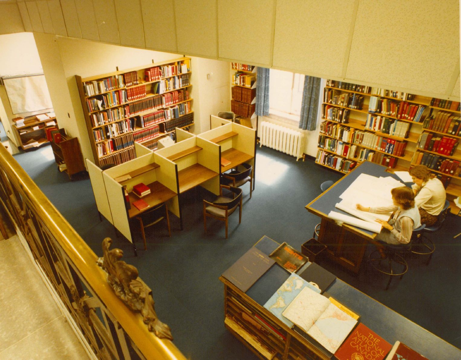 birds-eye view of people working at a table in the library