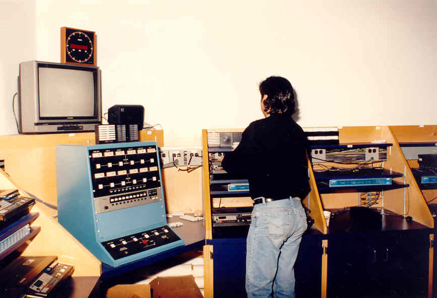 person with their back turned working with recording equipment