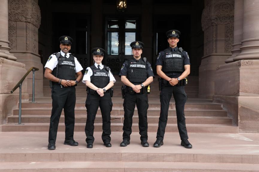 Two Protective Service Officers and Two Peace Officers in front of the Legislative Assembly of Ontario.