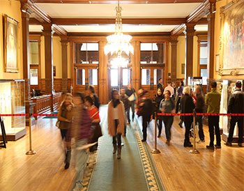 Group of people standing in the front lobby of the Legislative Building.