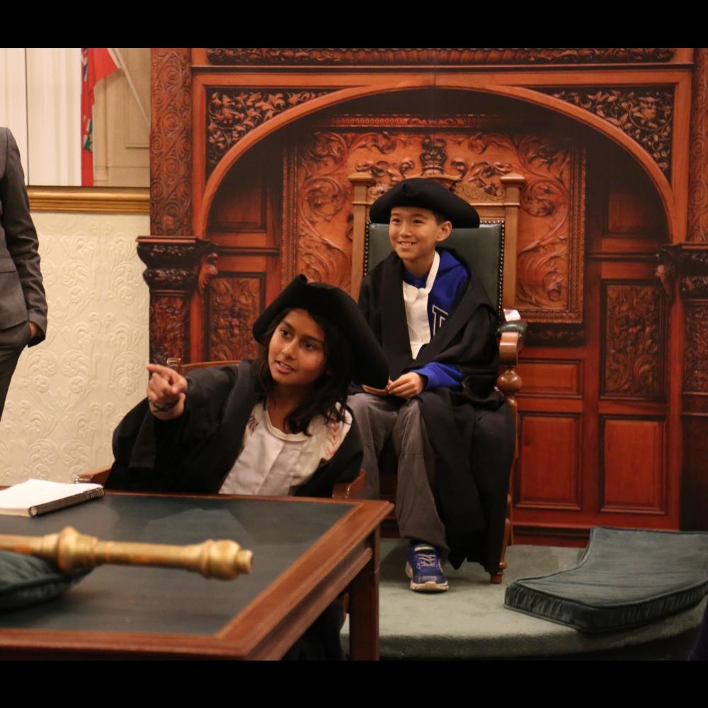 A picture of students taking part in a mock parliamentary debate at Ontario's Legislative Building.