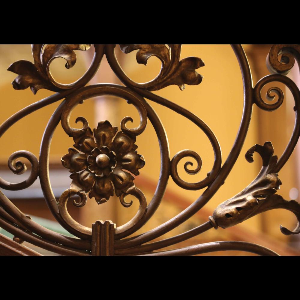 Close-up of ornate filigree details of the ironwork on the Grand staircase